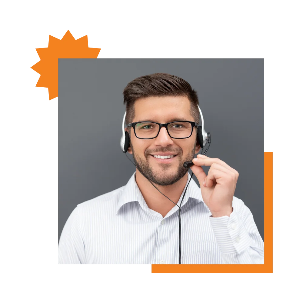 A smiling man with glasses and a headset, representing an electrician call answering service