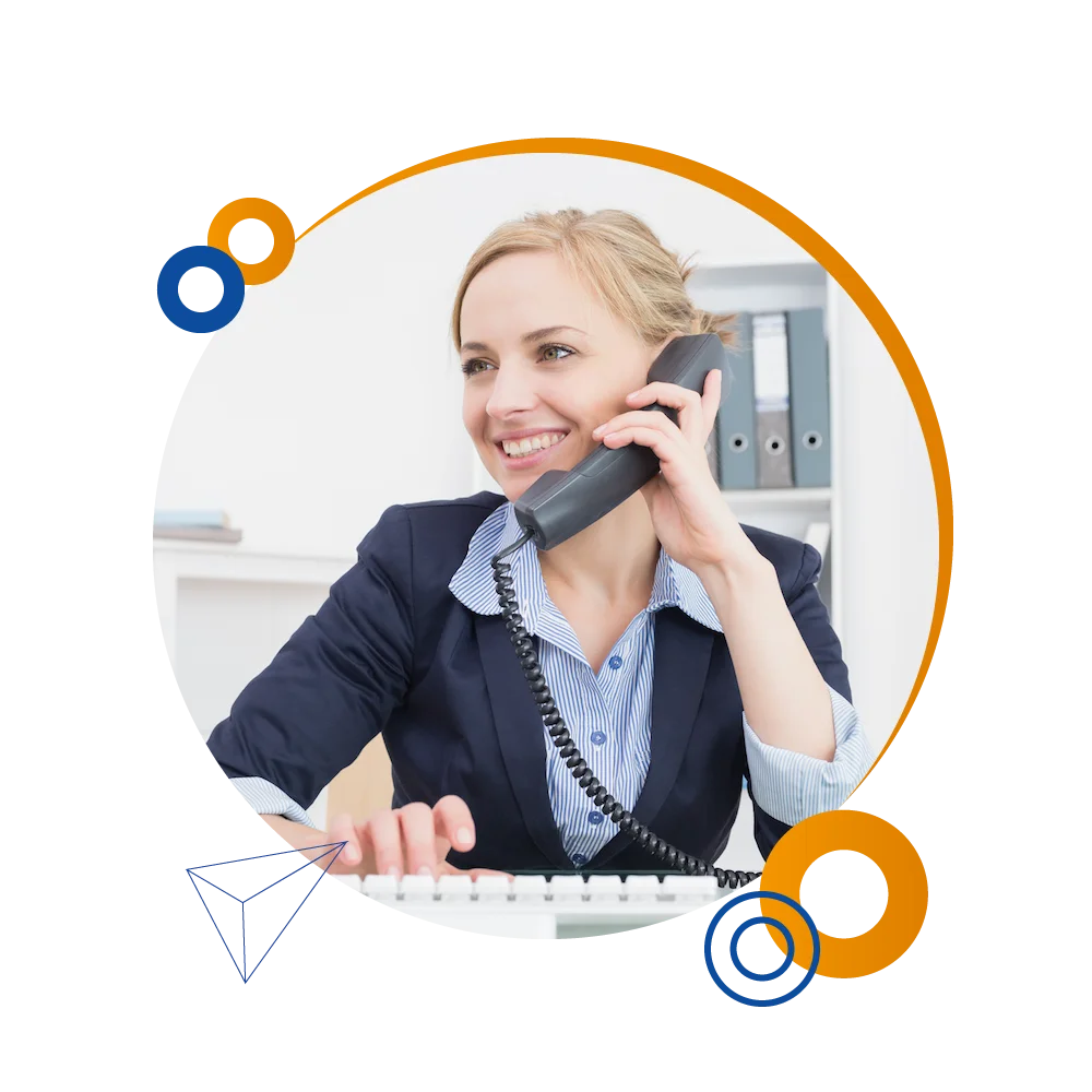 A woman converses on the phone while at her desk, exemplifying a Travel & Tourism answering service environment