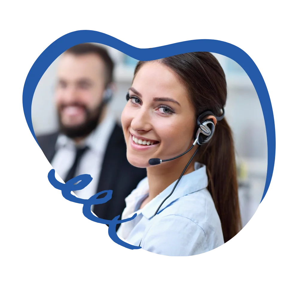 A woman wearing a headset smiles while speaking to a man in a suit, representing a positive professional exchange