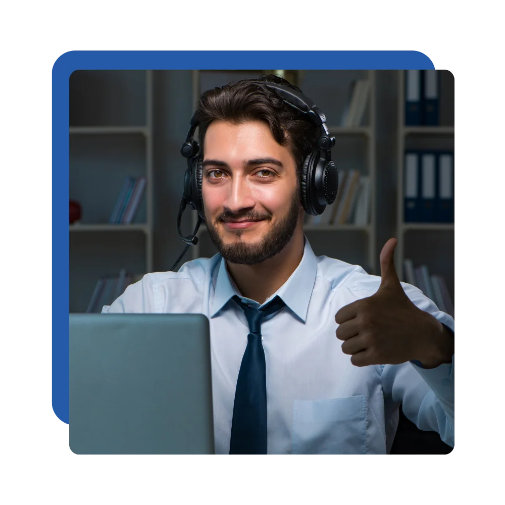 A man in a tie and headphones smiles and gives a thumbs up, conveying a positive and enthusiastic attitude