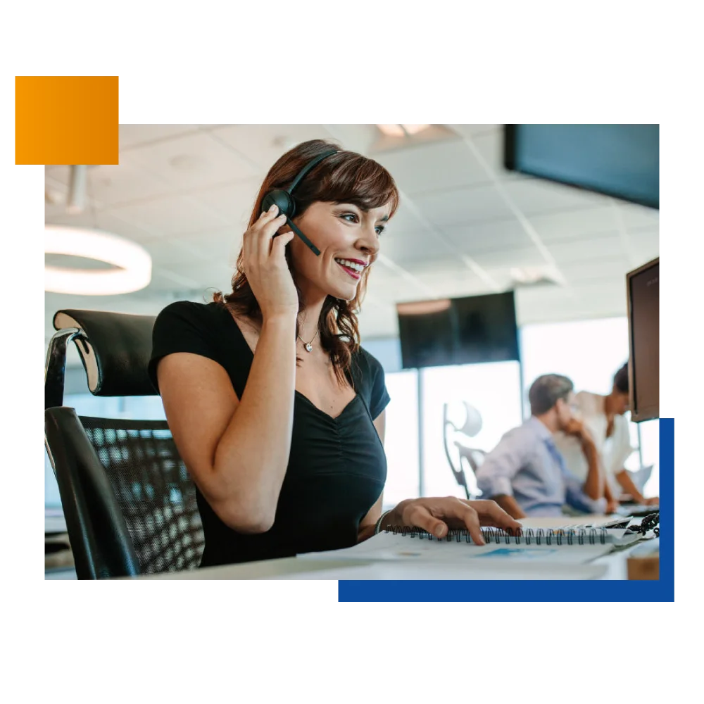 A woman at a call center speaking on the phone, demonstrating professionalism and concentration in her role