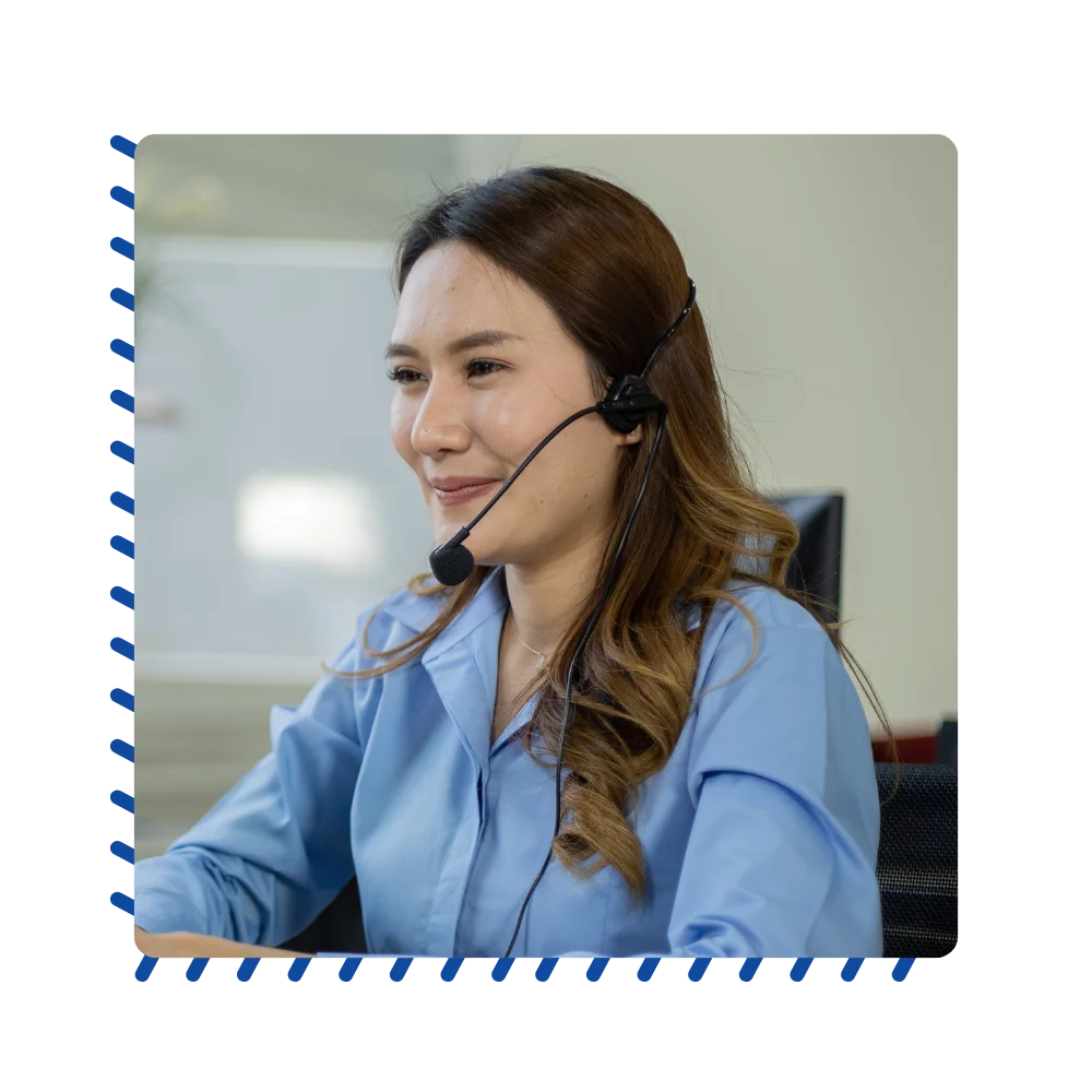 A woman donning a headset in an office environment, concentrating on her tasks while communicating effectively