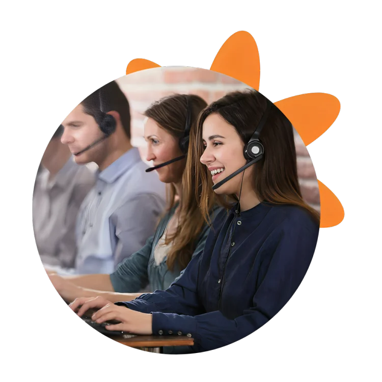 Three individuals wearing headsets engaged in conversation at a call center, focused on their tasks