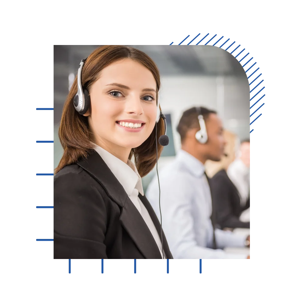 A smiling woman wearing headphones in a call center, engaged in conversation and providing customer support