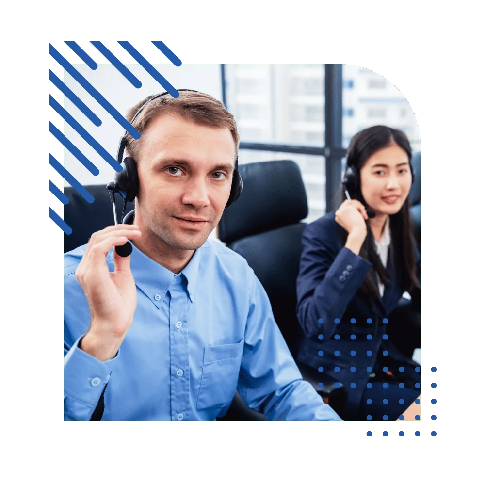 A group of call center agents engaged in conversation at their desks, equipped with headsets and computers