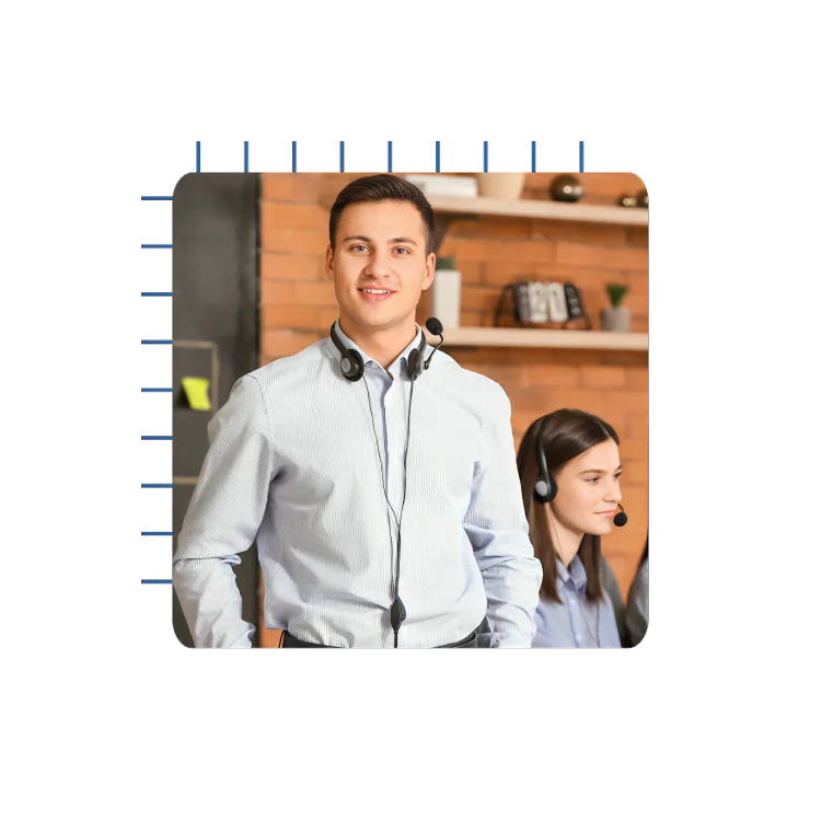 A man wearing a headset engages in conversation with a woman dressed in a blue shirt, both focused and attentive