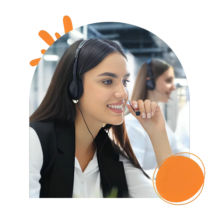 A woman wearing a headset, focused on her work in a modern office environment