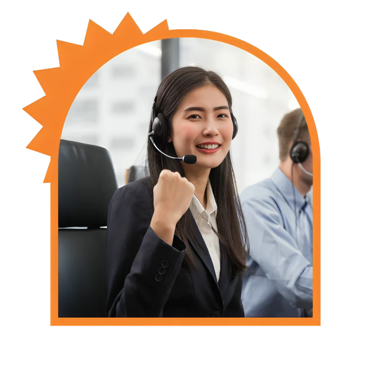 A cheerful woman in a headset is engaged in her work within a professional office space.